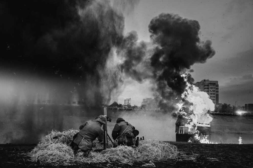 World War II German Soldiers Fired From A Mortar. Photo In Black