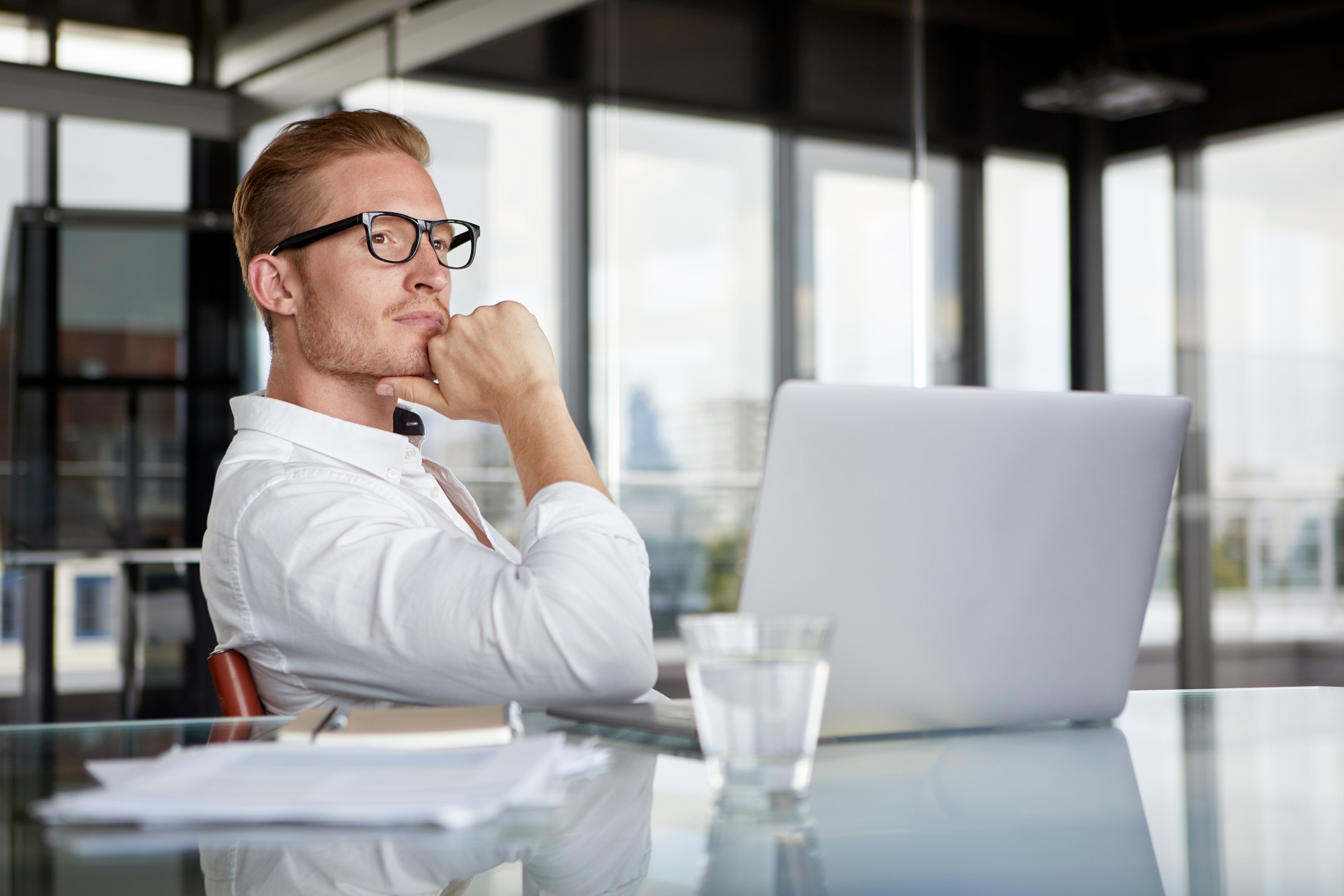 Businessman with laptop on desk in office thinking about SEO Tips for small businesses